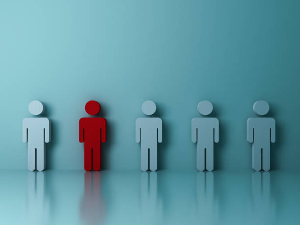 istock Stand out from the crowd and different creative idea concepts , One red man standing among other people on green background 648892408