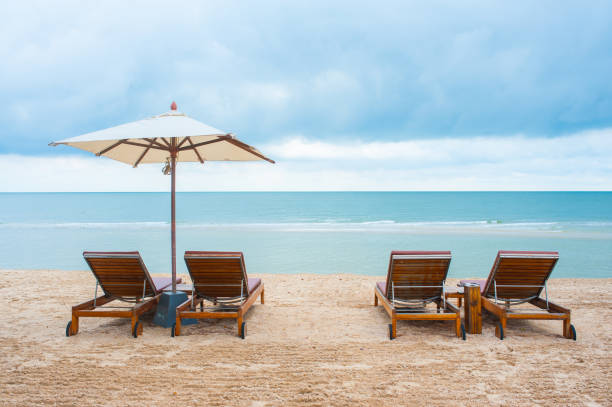 istock Beach chairs on the sand beach with cloudy blue sky 648899896