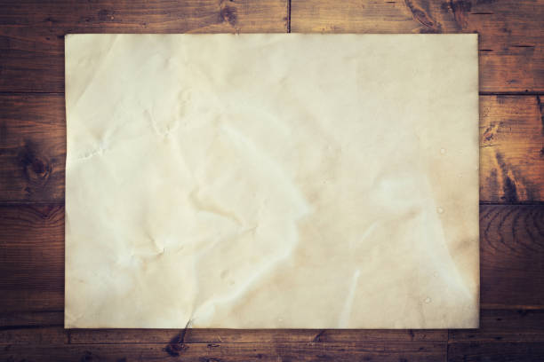 istock Old paper on wood background vintage with space 648906436