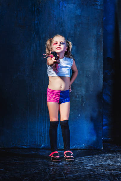 istock Little girl pointing in toy gun 648912854