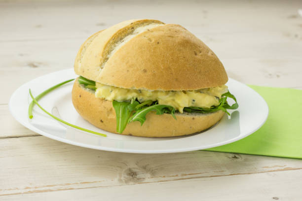istock White sandwich with egg and chive salad on a white plate 648912894