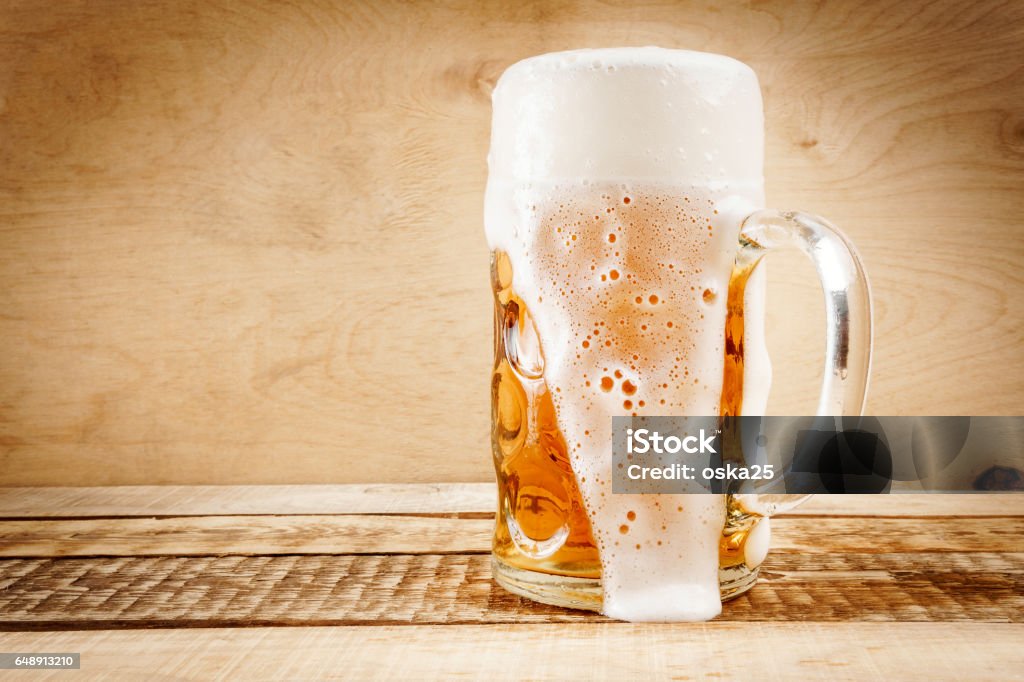 delicious beer on a wooden table delicious golden beer on old wooden table Beer - Alcohol Stock Photo