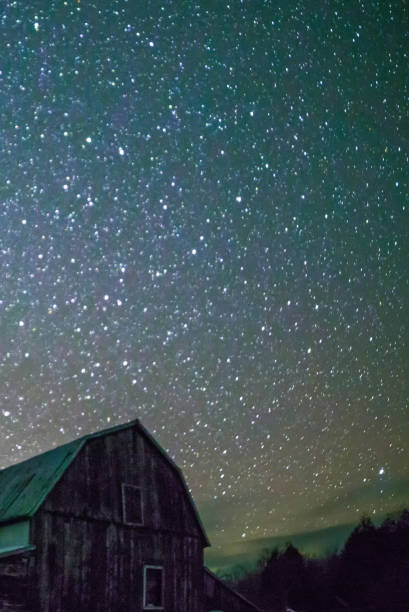 istock Rural barns at night with stars in winter 648923956
