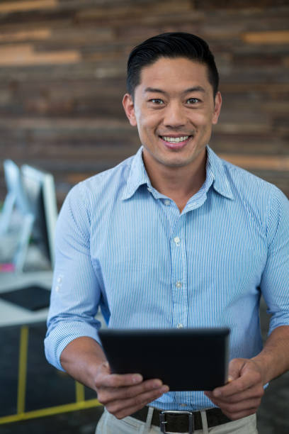 istock Portrait of smiling businessman using digital tablet 648924118