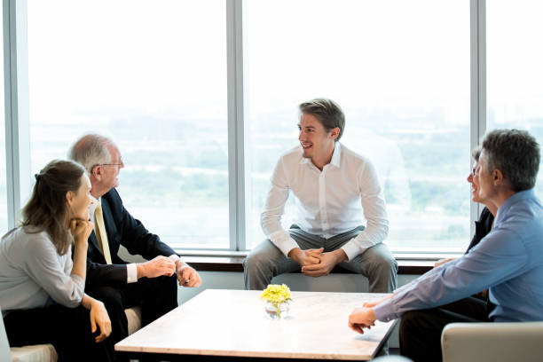 istock Business Colleagues Sharing Ideas in Lounge 648927512