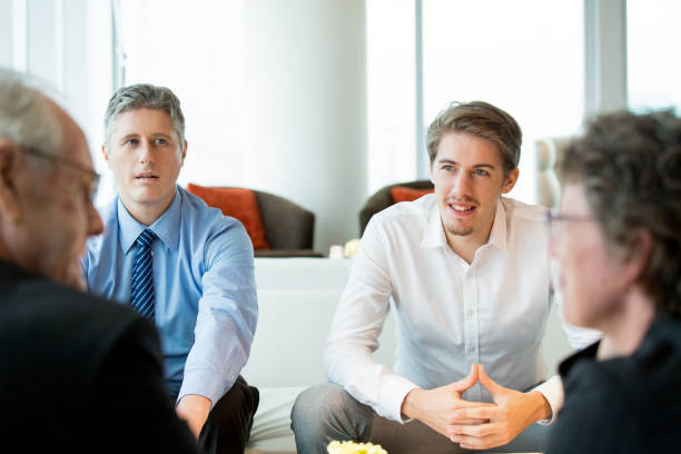 istock Four Business People Discussing Contract Terms 648927572
