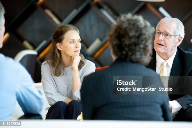 Senior Boss Explaining Ideas To Colleagues Stock Photo - Download Image Now - Meeting, High Society, Serious