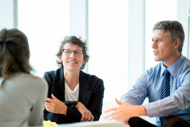 istock Three Business Colleagues Meeting in Lounge 648927740