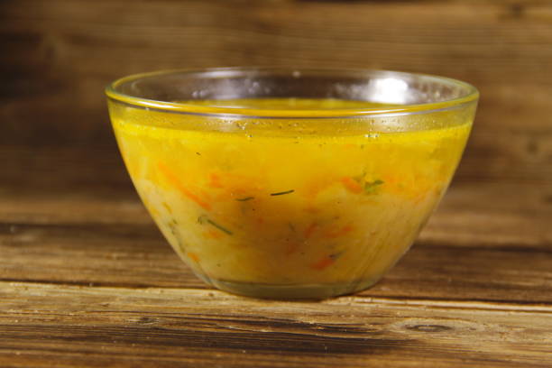 istock Soup in glass bowl on wooden table 648935738