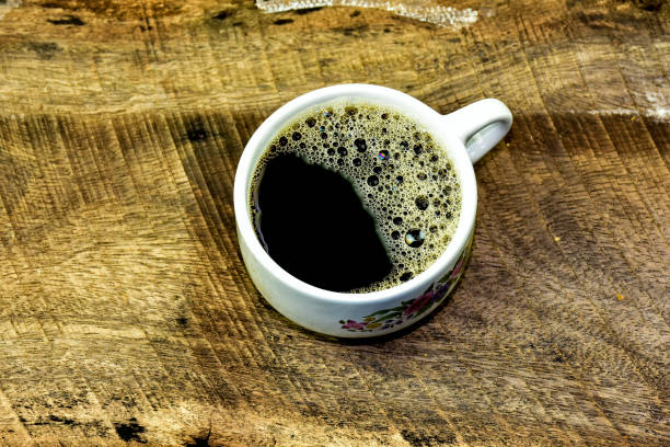 istock Black coffee and coffee bean  on wood background 648938352