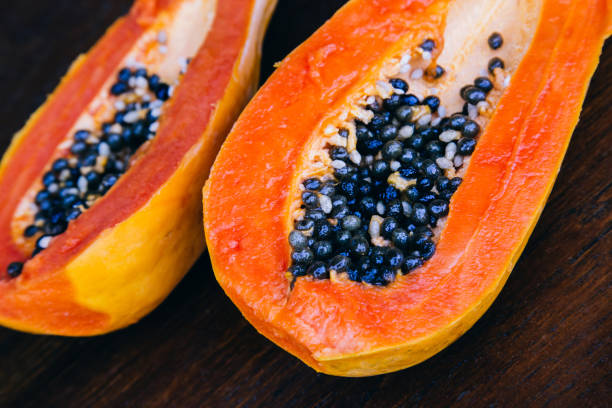 istock Papaya fruit on wooden background. 648938454