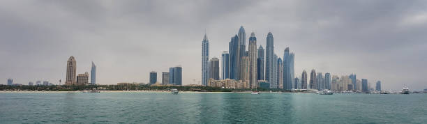 Panoramic view of Dubai from seaside Panoramic view of Dubai skyline from seaside dubai marina panorama stock pictures, royalty-free photos & images