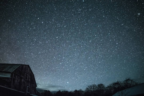 istock Rural barns at night with stars in winter 648942510
