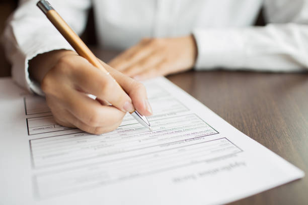 istock Female employee filling application form at table 648943006
