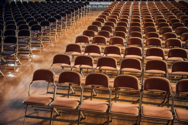 rows of empty chairs within school hall - school hall imagens e fotografias de stock