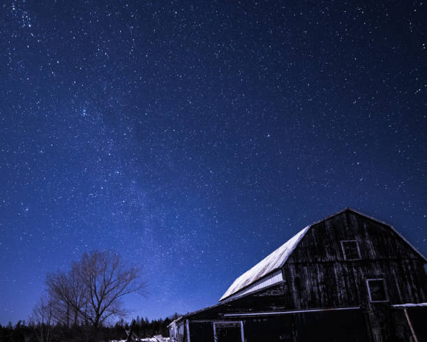 istock Rural barns at night with stars in winter 648946360