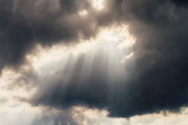 istock Gray storm clouds with rays of sunlight 648946696