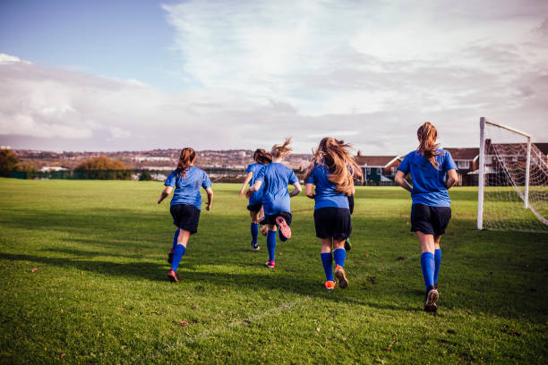 istock Girls Running onto a Soccer Playing Field 648947042