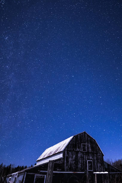istock Rural barns at night with stars in winter 648949822