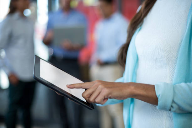 istock Mid section of businesswoman using digital tablet 648956972
