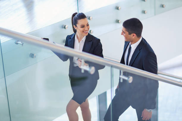 istock Business colleagues talking on stairs 648960796