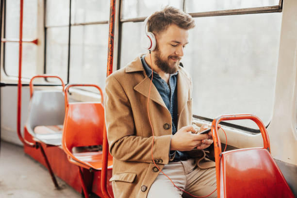 istock Handsome man enjoying music while traveling to his work by tramway 648960890