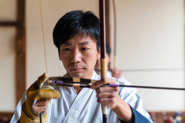 istock Young Japanese archer nocking his arrow 648967684