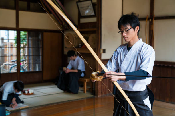 istock Young archer nocks his arrow 648967818