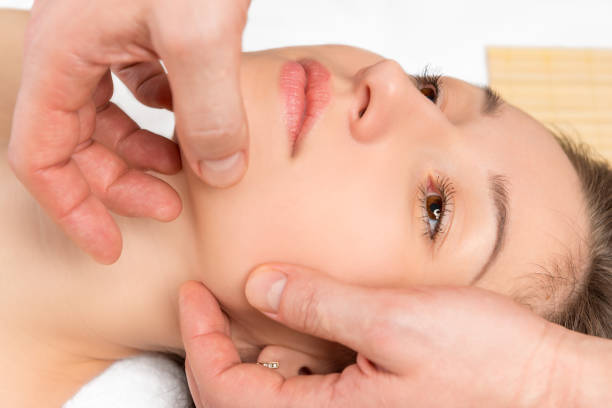 istock spa facial massage hands cosmetologist man closeup 648968236