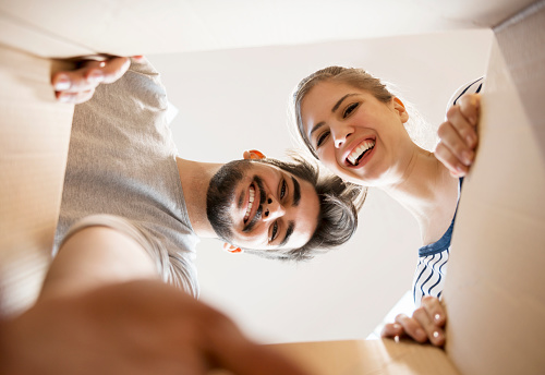 Young couple looking into the box