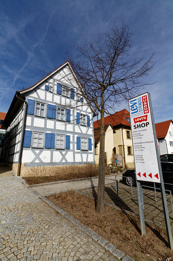 Entrance of the Levi Strauss birth house in Buttenheim, Bavaria, Germany on a sunny day. The half timbered birthplace is now a museum dedicated to the life and work of Levi Strauss, the inventor of the blue jeans