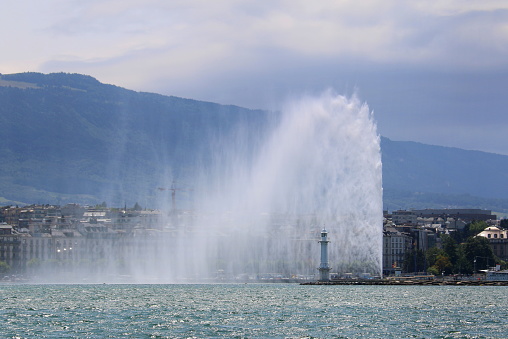Unusually strong wind was blowing the Fountain of Geneva sideways at Lake Geneva in Switzerland.