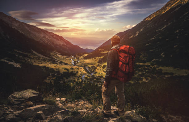 istock Traveler watching the sunset over the mountains 648986304