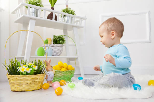 istock Easter egg hunt. Adorable child playing with Easter eggs at home 648994332