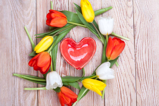 istock Heart shaped valentine gift with bunch of tulips 649003340