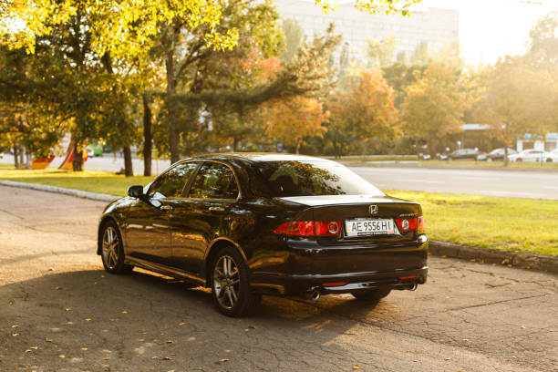 Honda Accord in the city Dnipro, Ukraine - october 01, 2016: Honda Accord dark color on the walkway of Dnipro city street, autumn time. Cityscape on sunset named animal stock pictures, royalty-free photos & images