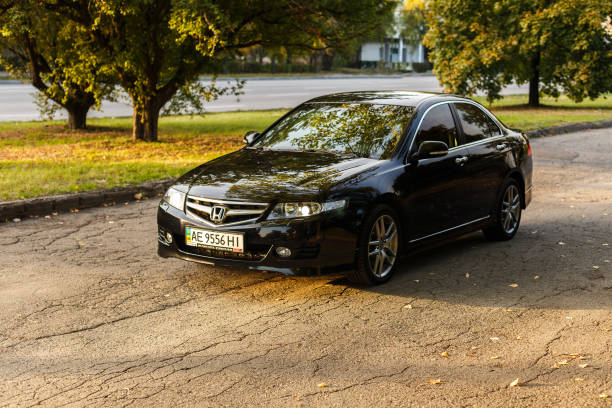 Honda Accord in the city Dnipro, Ukraine - october 01, 2016: Honda Accord dark color on the walkway of Dnipro city street, autumn time. Cityscape on sunset named animal stock pictures, royalty-free photos & images