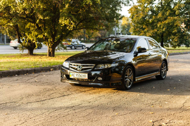 Honda Accord in the city Dnipro, Ukraine - october 01, 2016: Honda Accord dark color on the walkway of Dnipro city street, autumn time. Cityscape on sunset named animal stock pictures, royalty-free photos & images