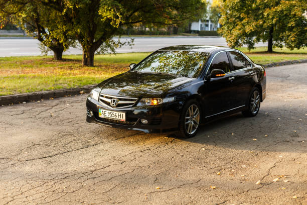 Honda Accord in the city Dnipro, Ukraine - october 01, 2016: Honda Accord dark color on the walkway of Dnipro city street, autumn time. Cityscape on sunset named animal stock pictures, royalty-free photos & images