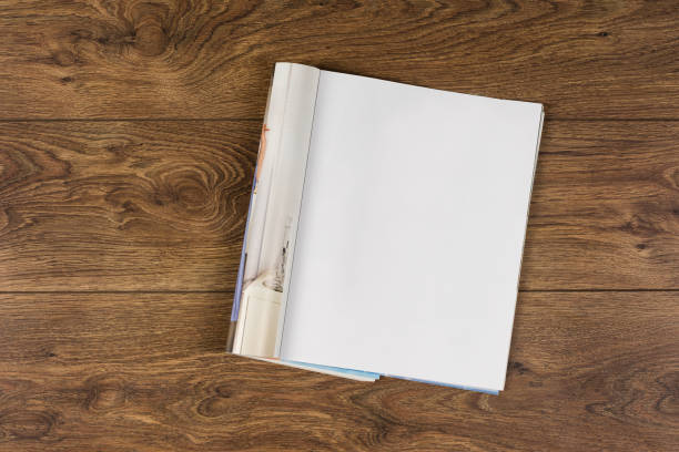 Mock-up magazines or catalog on wooden table background.