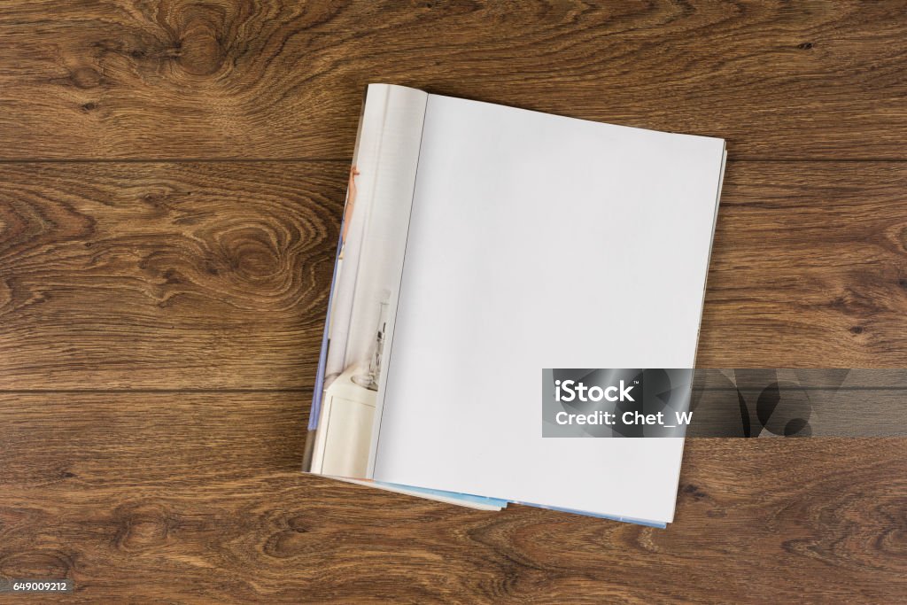 Mock-up magazines or catalog on wooden table background. Mock-up magazine or catalog on wooden table. Blank page or notepad on wood background. Blank page or notepad for mockups or simulations. Magazine - Publication Stock Photo