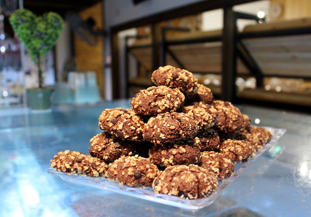 istock Chocolate shortbread biscuits with nuts in a pyramid shape on the shelf in the cafe 649009298