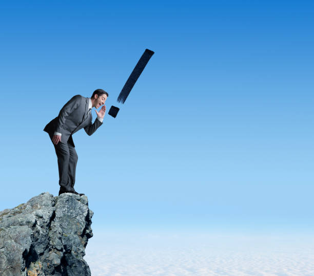 istock Exclamation Point Punctuating Businessman's Shouting From Mountaintop 649012116