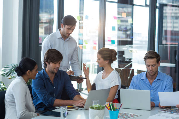 istock Team of graphic designers interacting with each other 649012348