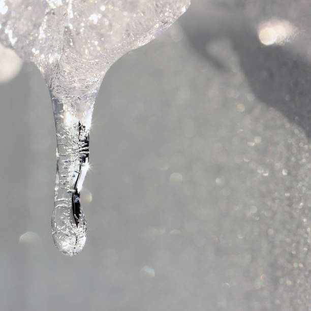 istock Icicle with sunbeams on frozen wall background. 649022178
