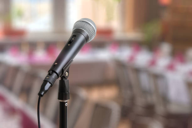 istock Speech or conference concept. Microphone on stand in front of audience room. 649030278