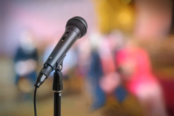 istock Speech or conference concept. Microphone on stand in front of audience. 649030698