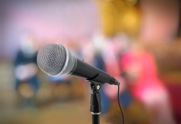 istock Speech or conference concept. Microphone on stand in front of audience. 649030704
