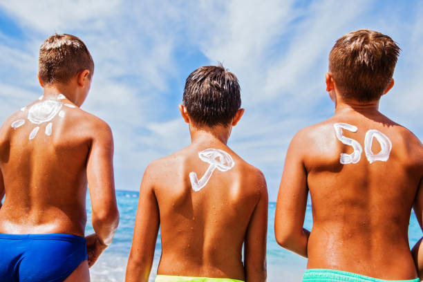 istock Boys with sun protection on the beach 649034046
