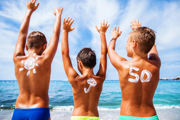 istock Boys with sun protection on the beach 649034054